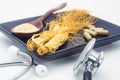 Stethoscope and Ginseng root powder for capsules medicine Royalty Free Stock Photo