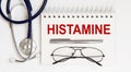 Stethoscope,glasses and pen with notepad with text HISTAMINE