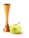 Stethoscope an green apple, measuring tape