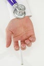 Stethoscope on a hand holding a cigarette Royalty Free Stock Photo