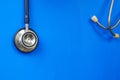 Stethoscope hanging over blue background ideal for medical and healthcare concept