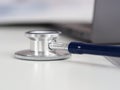 Stethoscope head lying on at empty doctor worktable