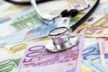 Stethoscope on heap of euro notes Royalty Free Stock Photo