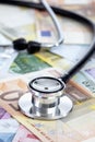 Stethoscope on heap of euro notes Royalty Free Stock Photo