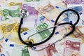 Stethoscope on heap of euro notes Royalty Free Stock Photo
