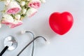 Stethoscope, heart, flowers on the white wooden background. International doctor's or nurse's day. Happy Royalty Free Stock Photo