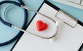 Stethoscope, Heart, Keyboard And Notepad On Tile Background Royalty Free Stock Photo