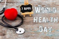 Stethoscope and heart symbol with inscription World Health Day o Royalty Free Stock Photo