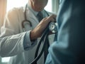A stethoscope is held in the close-up view of a healthcare professional\'s hands, symbolizing the importance of medical care