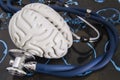 Stethoscope and human brain lied on recorded x-ray film surveys of computed tomography SCT or magnetic resonance imaging MRI. Royalty Free Stock Photo