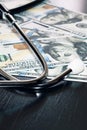 Stethoscope on hundred dollar bills close up Royalty Free Stock Photo