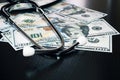 Stethoscope on hundred dollar bills close up Royalty Free Stock Photo