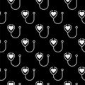 Stethoscope icon with heart shape seamless pattern isolated on black background Royalty Free Stock Photo