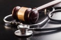 Judge gavel and stethoscope , close-up view Royalty Free Stock Photo