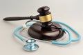 Stethoscope with judge gavel on gray Royalty Free Stock Photo