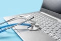 Stethoscope keyboard laptop computer isolated on blue background. Healthy Hardware. Telemedicine concept. Computer and gadget Royalty Free Stock Photo