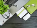 stethoscope laptop desktop view of doctor paper from above black wooden Royalty Free Stock Photo