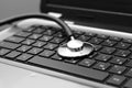 Stethoscope on laptop keyboard Royalty Free Stock Photo