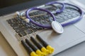 Stethoscope on laptop keyboard. Health care or IT security concept. Laptop repair concept. Computer repair concept Close-up view. Royalty Free Stock Photo