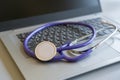 Stethoscope on laptop keyboard. Health care or IT security concept. Laptop repair concept. Computer repair concept Close-up view. Royalty Free Stock Photo