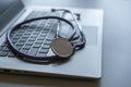 Stethoscope on laptop keyboard. Health care or IT security concept. Laptop repair concept. Computer repair concept Close-up view. Royalty Free Stock Photo