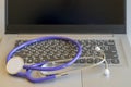 Stethoscope on laptop keyboard. Health care or IT security concept. Laptop repair concept. Computer repair concept Close-up view. Royalty Free Stock Photo