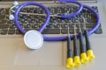 Stethoscope on laptop keyboard. Health care or IT security concept. Laptop repair concept. Computer repair concept Close-up view. Royalty Free Stock Photo