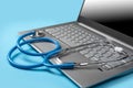 Stethoscope On Laptop Keyboard. Online doctor consultation, Healthcare and medical. Laptop diagnosis with stethoscope on blue Royalty Free Stock Photo