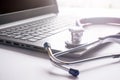 Stethoscope lay on  computer with pen and glasses, documents. work space Royalty Free Stock Photo