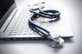 Stethoscope lay on  computer with pen and glasses, documents. work space of doctor Royalty Free Stock Photo
