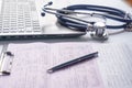 Stethoscope lay on  computer with pen and glasses, documents. work space Royalty Free Stock Photo