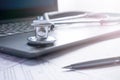 Stethoscope lay on  computer with pen and glasses, documents. work space Royalty Free Stock Photo
