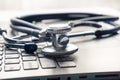 Stethoscope lay on  computer with pen and glasses, documents. work space Royalty Free Stock Photo