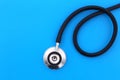 The stethoscope lies on a blue background with a place for text.