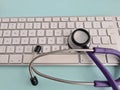 Stethoscope lies on computer keyboard in doctor office closeup and telemedicine Royalty Free Stock Photo