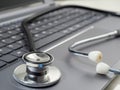 Stethoscope lies on laptop keyboard Royalty Free Stock Photo