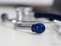 Stethoscope lying on at empty doctor worktable