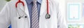 Stethoscope lying on male doctor chest in office Royalty Free Stock Photo
