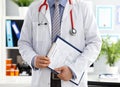Stethoscope lying on male doctor chest in office Royalty Free Stock Photo