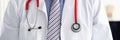 Stethoscope lying on male therapeutist doctor chest Royalty Free Stock Photo