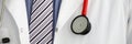 Stethoscope lying on male therapeutist doctor chest Royalty Free Stock Photo