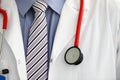 Stethoscope lying on male therapeutist doctor chest Royalty Free Stock Photo