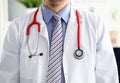 Stethoscope lying on male therapeutist doctor chest Royalty Free Stock Photo