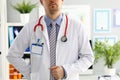 Stethoscope lying on male therapeutist doctor chest Royalty Free Stock Photo