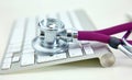 Stethoscope lying on a table an open book Royalty Free Stock Photo