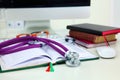 Stethoscope lying on a table on an open book Royalty Free Stock Photo