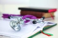 Stethoscope lying on a table an open book Royalty Free Stock Photo