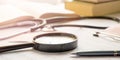 Stethoscope, magnifier, pen and books lay on cardiograms on table. sun glare from window Royalty Free Stock Photo