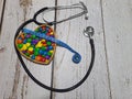 Stethoscope, measuring tape and a heart-shaped bowl with colorful candies . Royalty Free Stock Photo