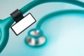 Stethoscope with medical ID tag on blue background Royalty Free Stock Photo